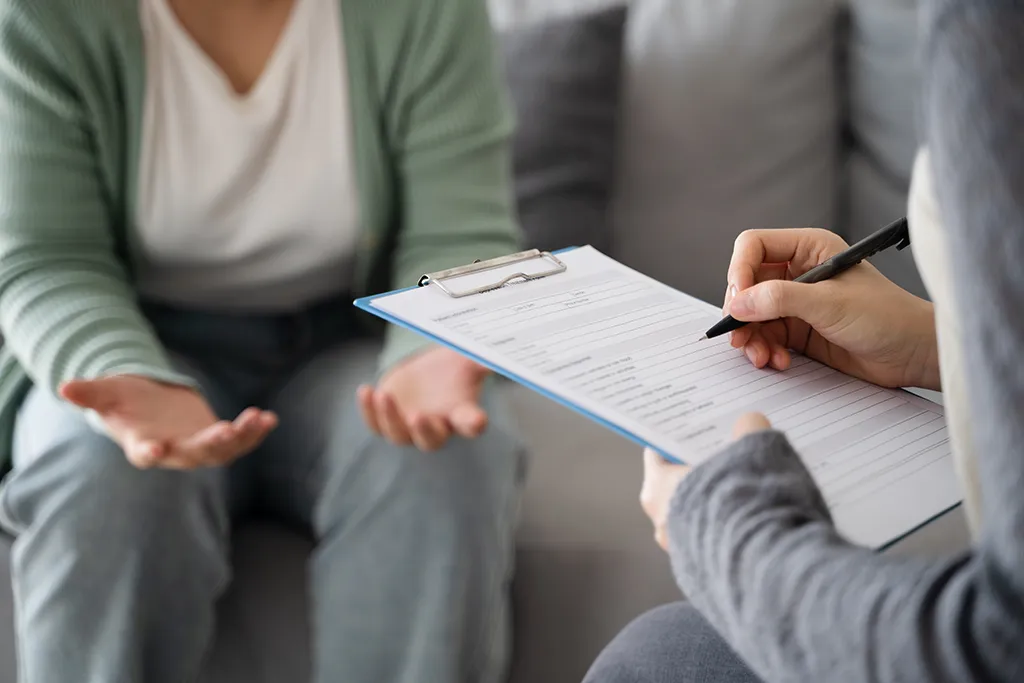 Mental health professional using digital tools in a modern office setting Mental health professional using digital tools in a modern office setting